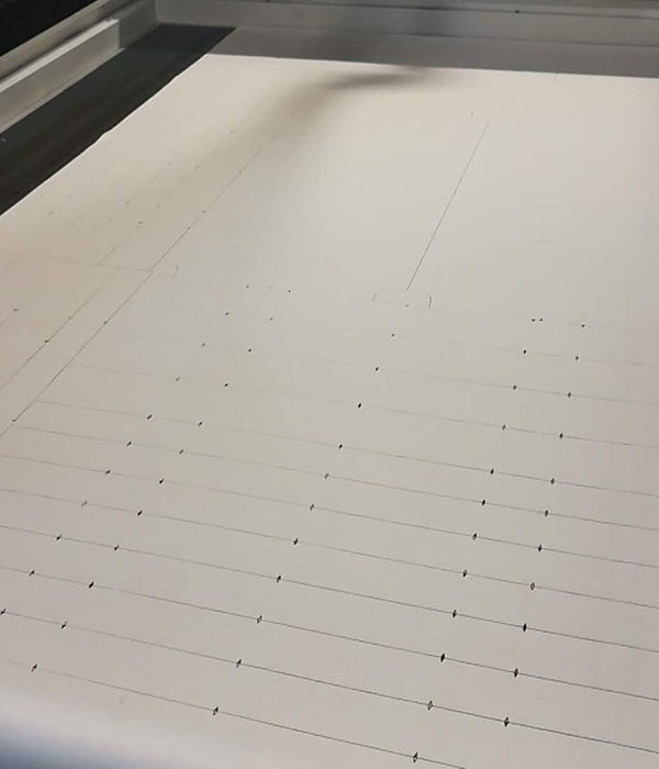 A cut path marked out on a foam sheet on the CNC table